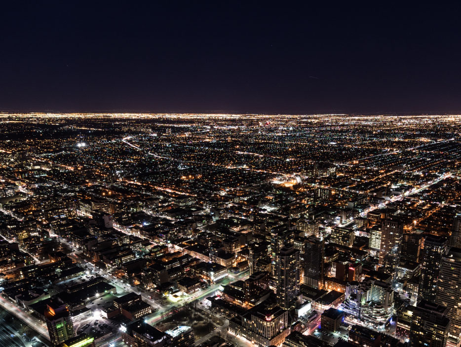 An aerial view of a big city grid lit up at night.