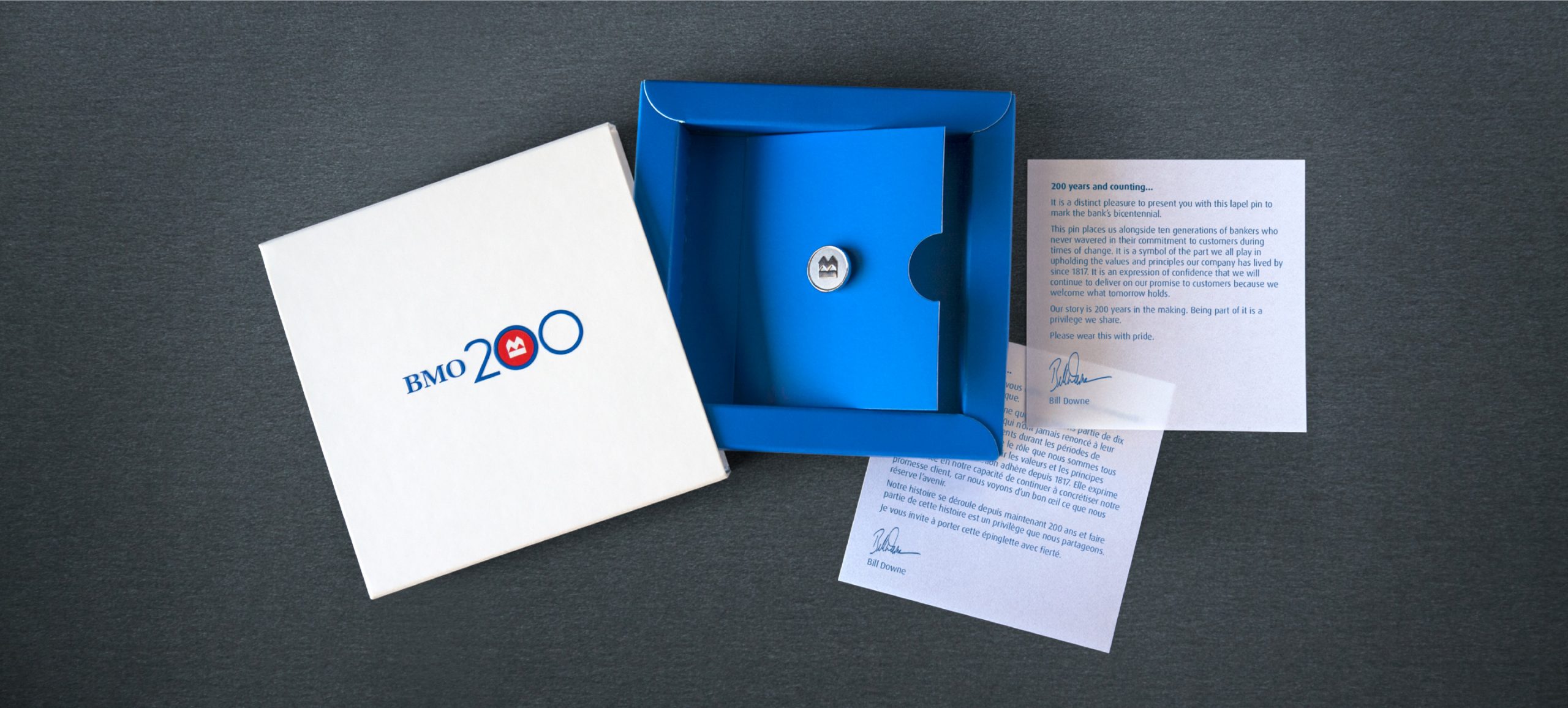 The packaging holding the BMO pin along with a booklet and letters are displayed.