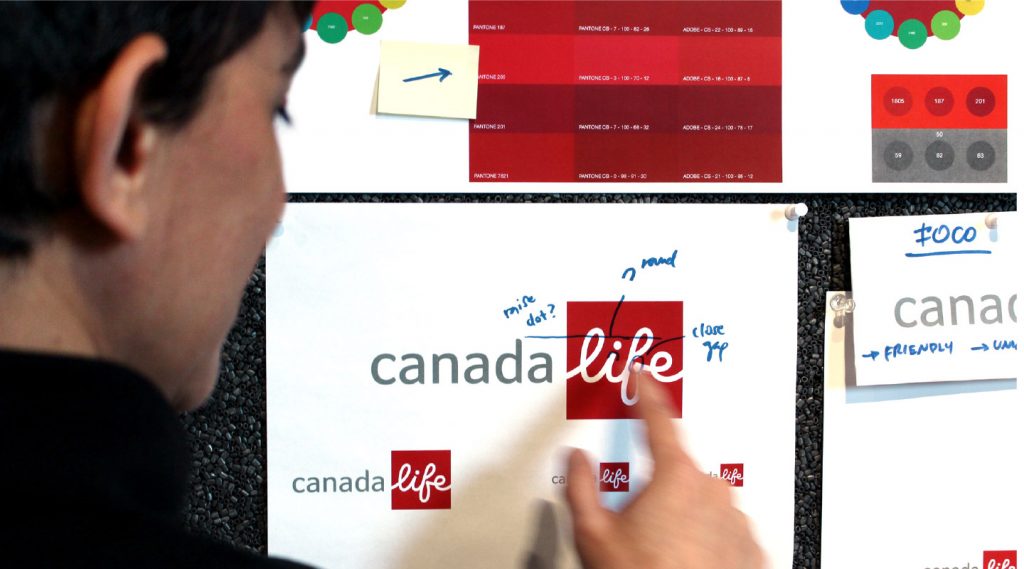 Working process shot of the Canada Life logo with notations and various colour references.
