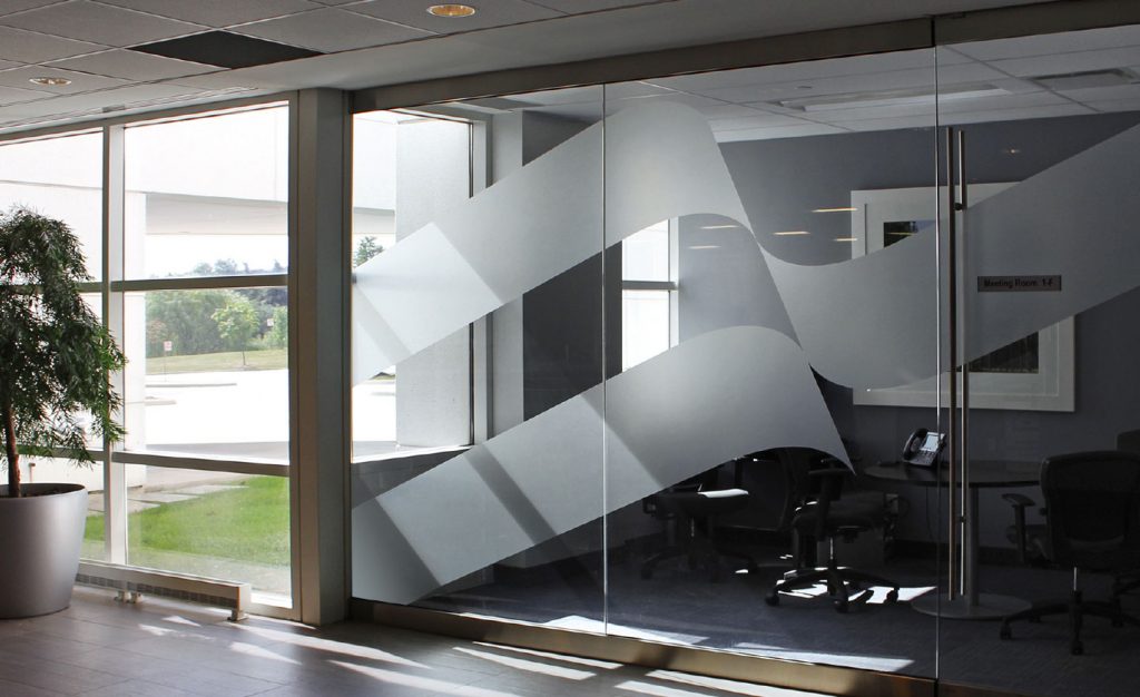Alectra’s supergraphic flag is applied in a transparent finish to a glass office wall.