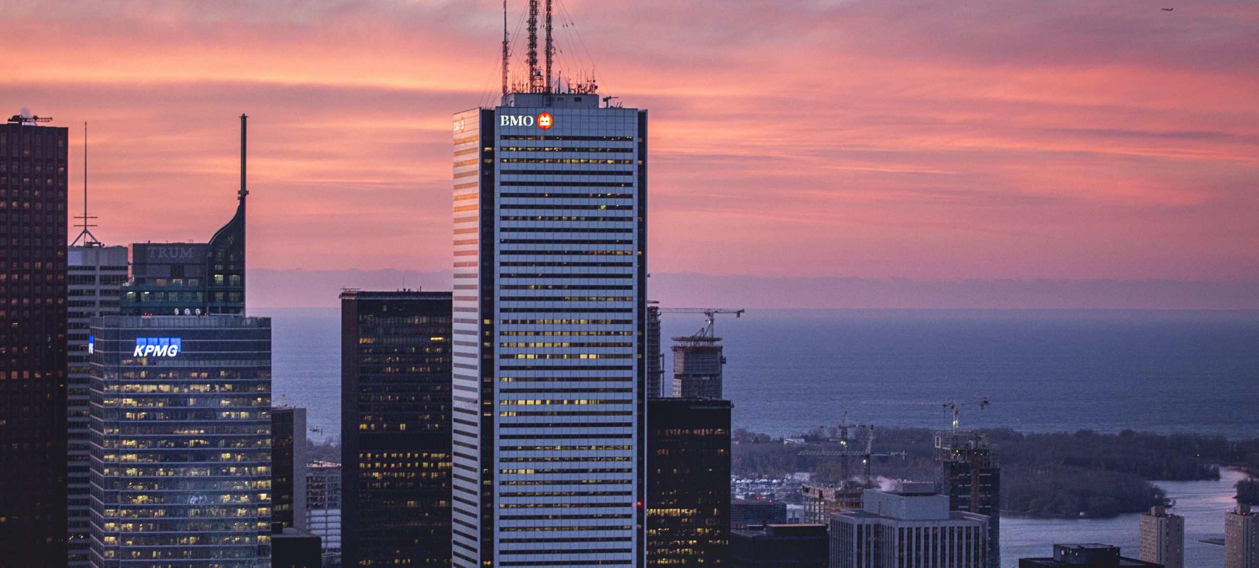 The Toronto skyline at sunset featuring the BMO logo sign designed by Ove atop First Canadian Place.