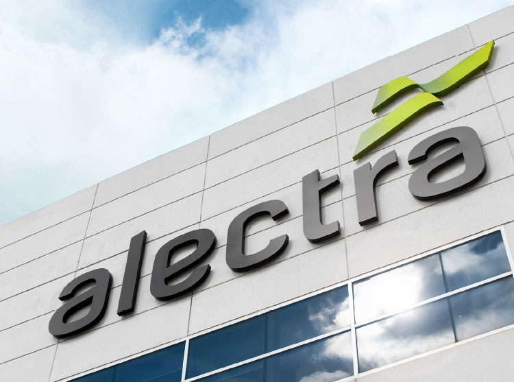 Exterior sign of Alectra's new logo on a building façade against a blue sky