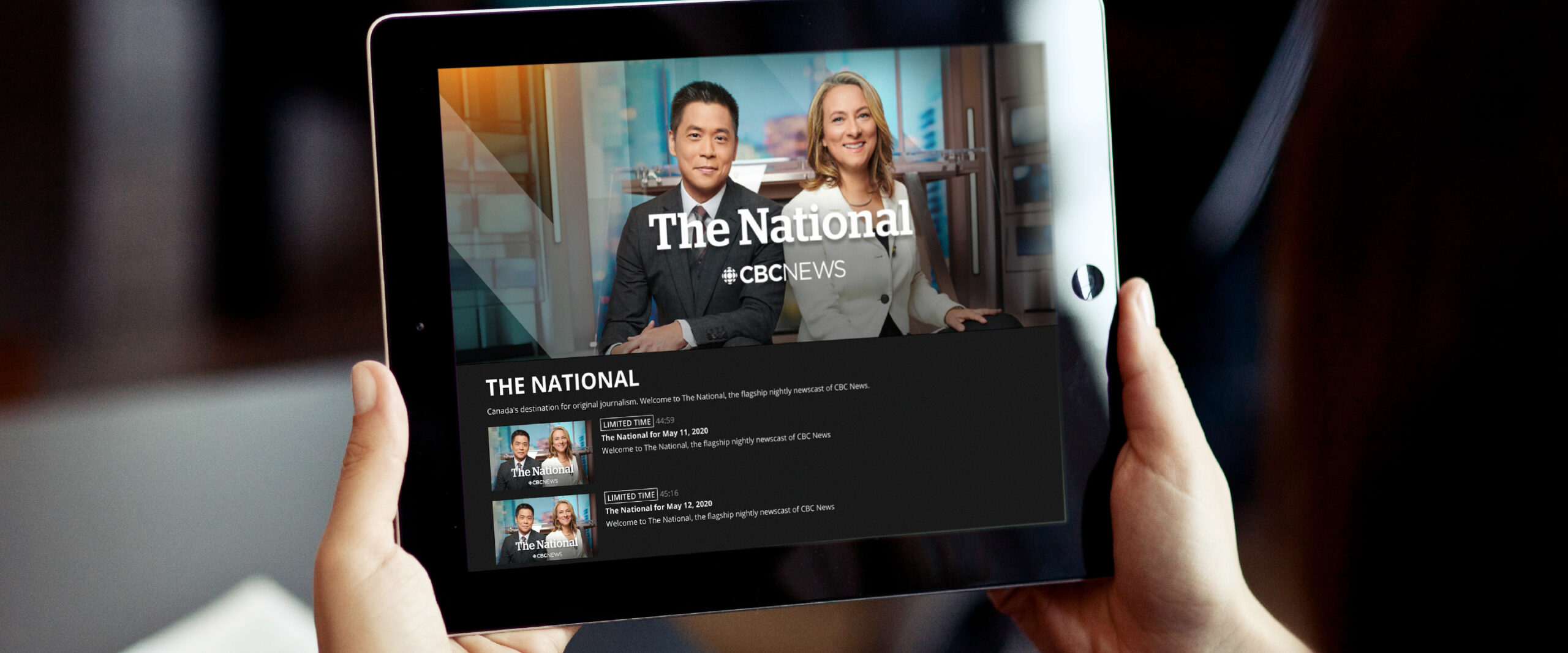 Closeup of a person holing up a table that shows The National's streaming video page