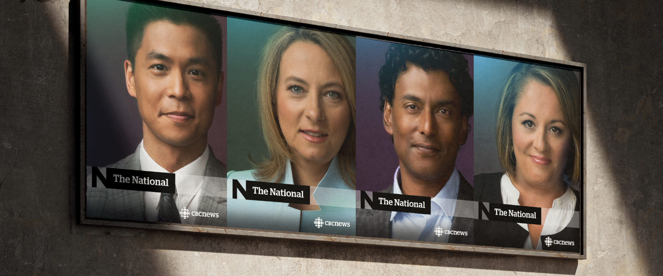 The National's outdoor posters on a wall. Every poster shows a portrait of each of the news anchors with the new logo