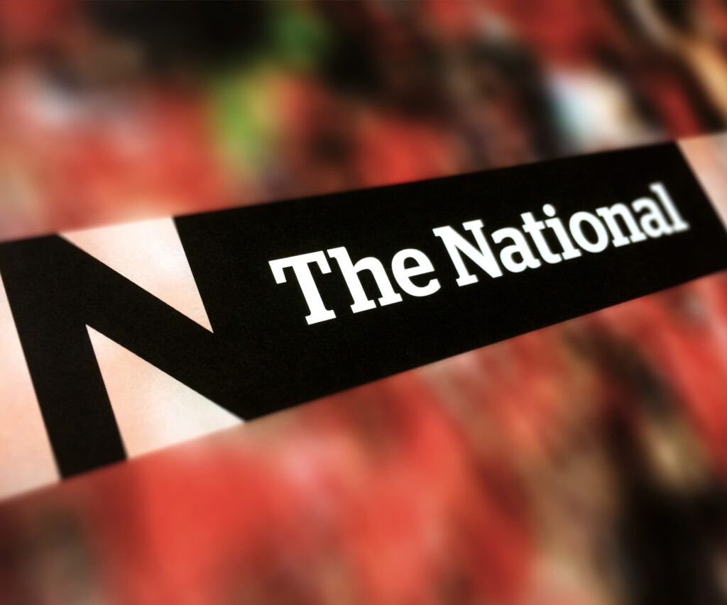 Closeup of the new National logo on a blurred red background