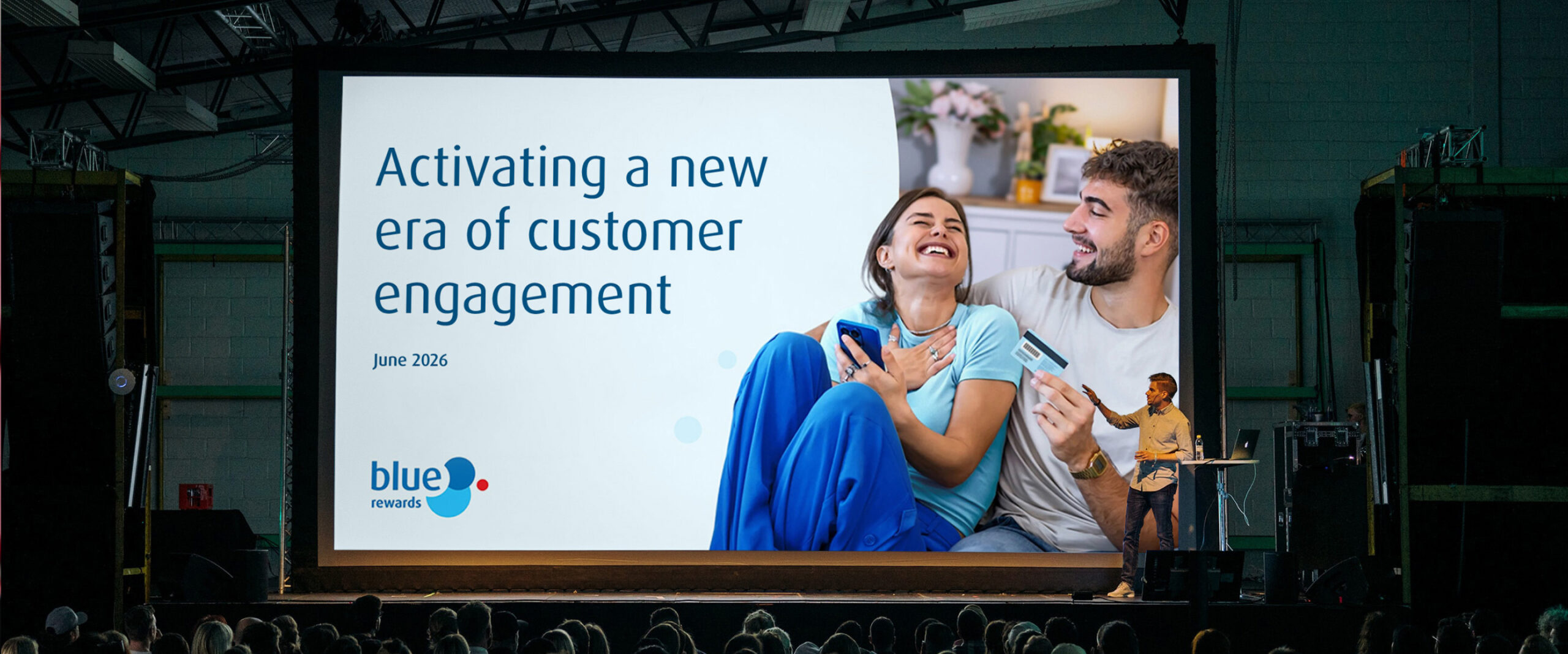 Image of a Blue Rewards presentation on a large screen, in a conference room